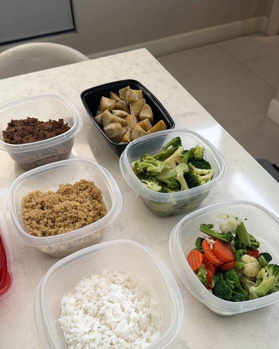 Prepped components portioned into containers: rice, quinoa, tofu and mixed vegetables.